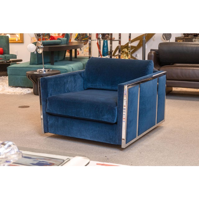 A pair of Milo Baughman cube club chairs. This lovely pair of modern accent lounge chairs feature a bright blue velvet...