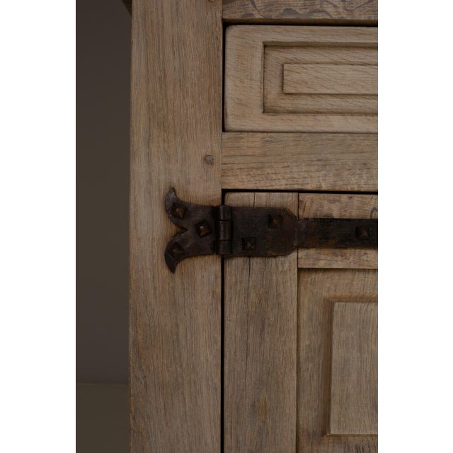 This 1970s French Primitive oak buffet features a substantial, architectural presence defined by its paneled doors, robust...