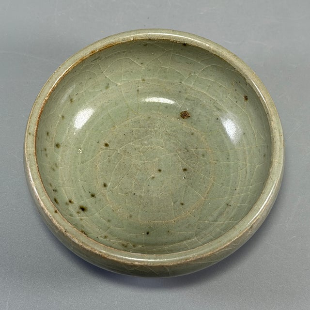 Fine antique Chinese celadon bowl. Compact rounded thick‑walled form with natural crackled celadon glaze, a charming...