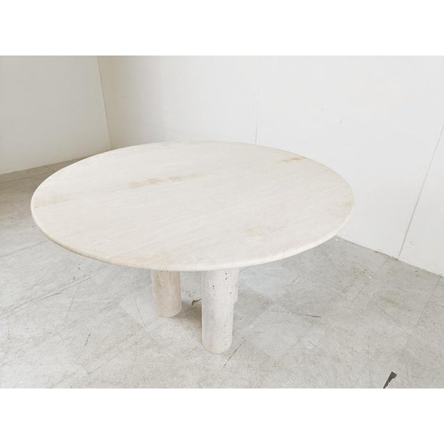 Beautiful dining table made from travertine stone with three cillindrical legs. Good looking natural travertine stone....