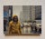 The painting captures a solitary figure in a vibrant yellow raincoat, navigating a rain-soaked urban landscape. The muted...