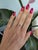 A rare AAA padparadscha sapphire glows in its signature pink-orange at the centre of this solid two-tone 14K white and...