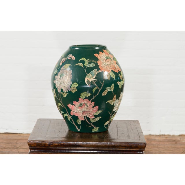 A vintage Chinese handcrafted green vase from the mid-20th century, with incised floral and bird decor. Created in China...