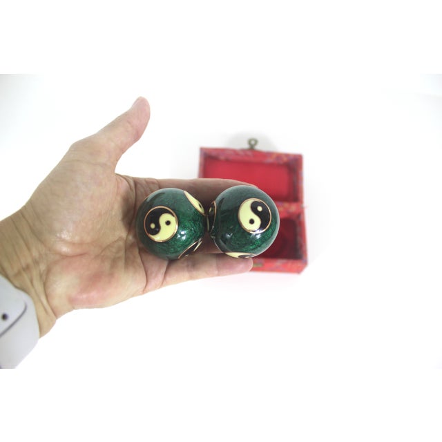 Vintage pair of Cloisonné Chinese musical stress balls with a dark green base colour with Yin-Yang symbols. These make a...