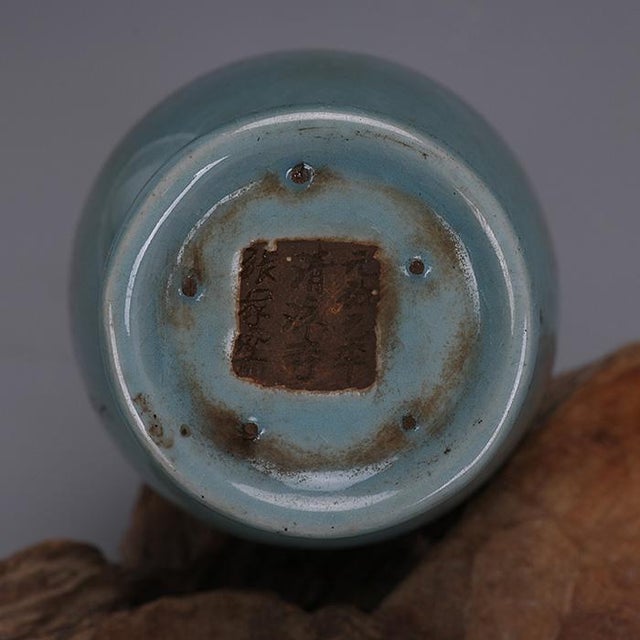 Elegant Chinese ceramic vase finished in soft sky blue glaze with delicate natural crackle texture. It features a wide...