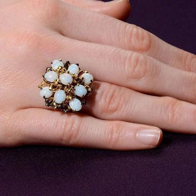 This is part of Chairish’s Fine Jewelry assortment. Vintage oval opal cocktail ring, circa 1950. This 12 karat yellow gold...
