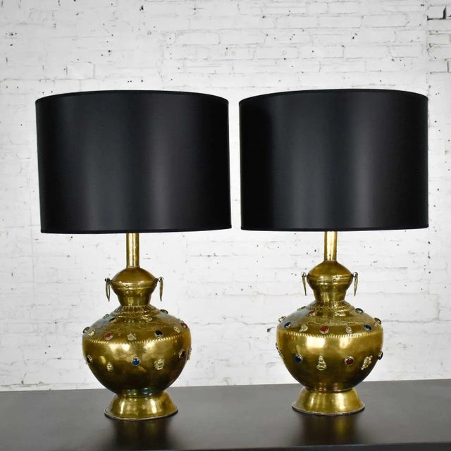 Stunning pair of hand hammered Tibetan brass lamps with glass jewels, etched and applied details, and new black Fenchel...