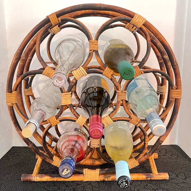 Vintage burnt bamboo wine rack with rattan wrappings. This large circular rack holds seven bottles and measures 17” wide x...