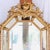 An eye-catching confection of Rococo decorative elements, combined in a cushion mirror with sober classical architectural...