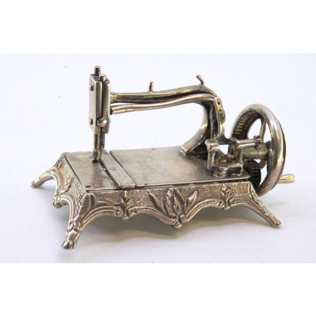 Miniature Sewing Machine in Silver with Reliefs and Applications, in Very Good conditions. Designed 1980 to 1989 This...