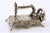 Miniature Sewing Machine in Silver with Reliefs and Applications, in Very Good conditions. Designed 1980 to 1989 This...