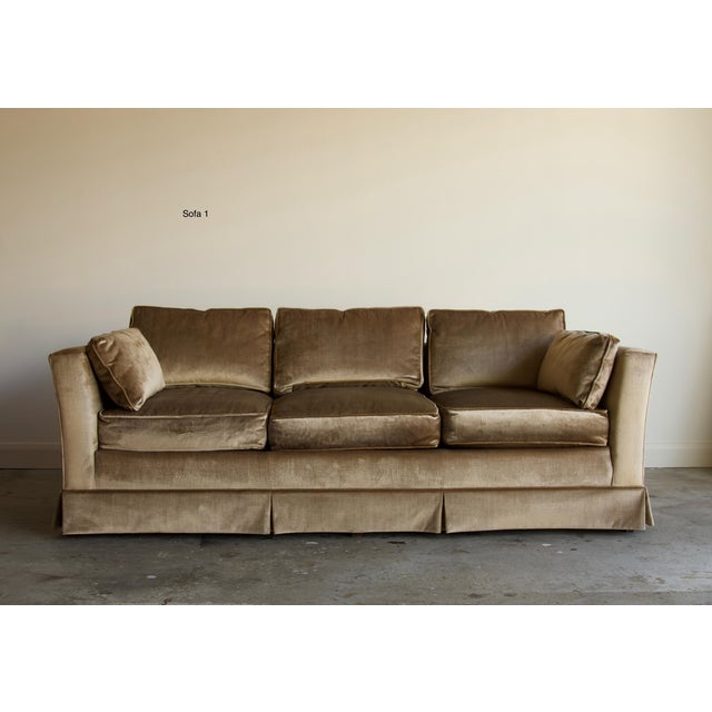 A pair of late 20th century sofas in champagne velvet, built on a clean squared frame with canted arms and a tailored kick...