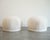A striking pair of 1970s swiveling poufs by Directional Furniture, fully restored and reimagined for modern interiors....
