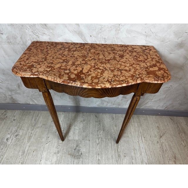 Elegant small Art Deco console table in walnut, topped with a beautiful marble slab in warm brown and pink hues. Its...