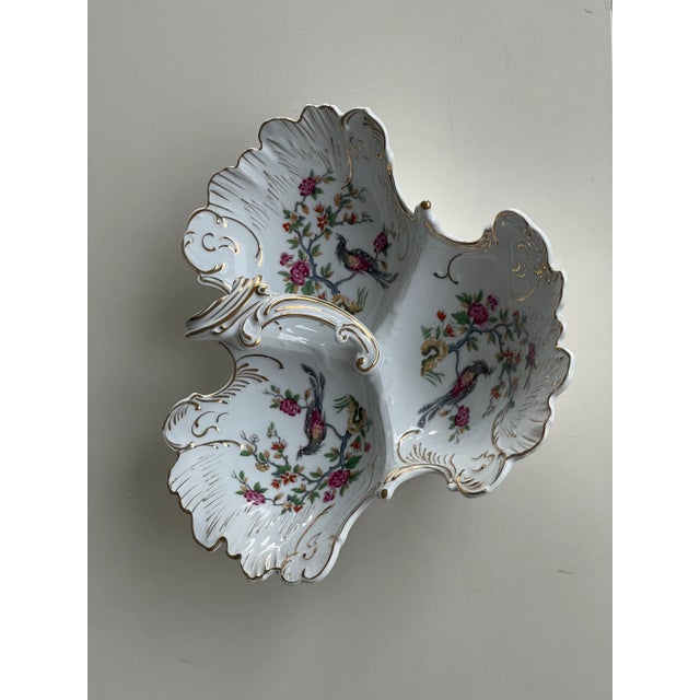 It's a beautiful Handpainted and Handled three section bowl or platter. It's scalloped on the edges and gilded in gold....