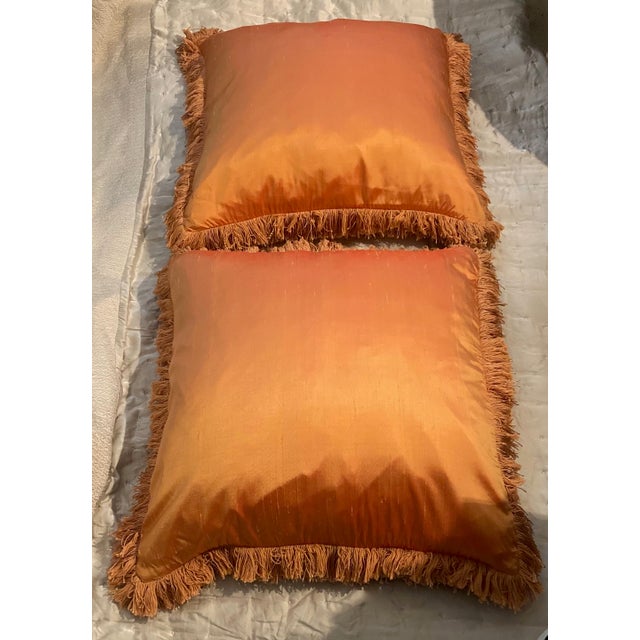 Lustrous Mandarin color textured silk pillows with hidden zipper covers. These square pillows are trimmed in a thick...