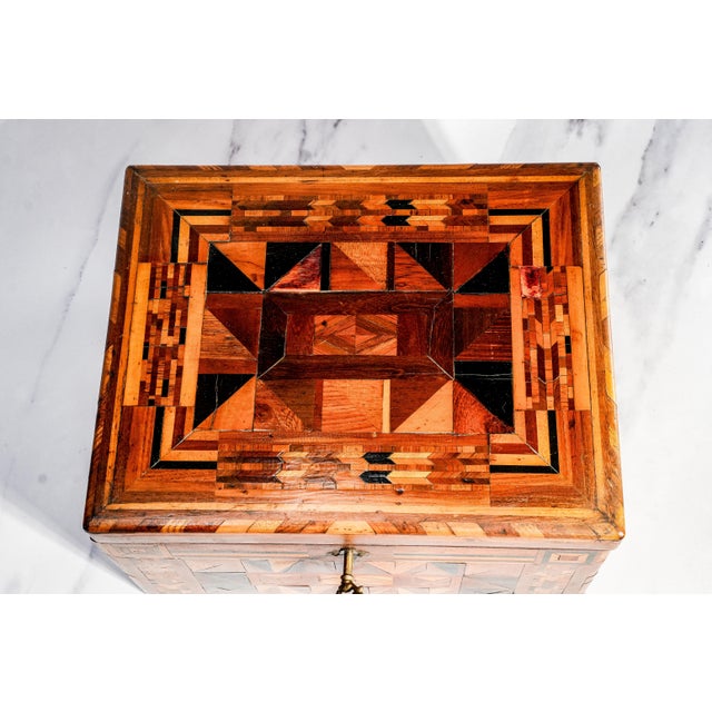 A remarkable example of nineteenth-century craftsmanship, this large Victorian inlaid wood box is a true statement piece,...