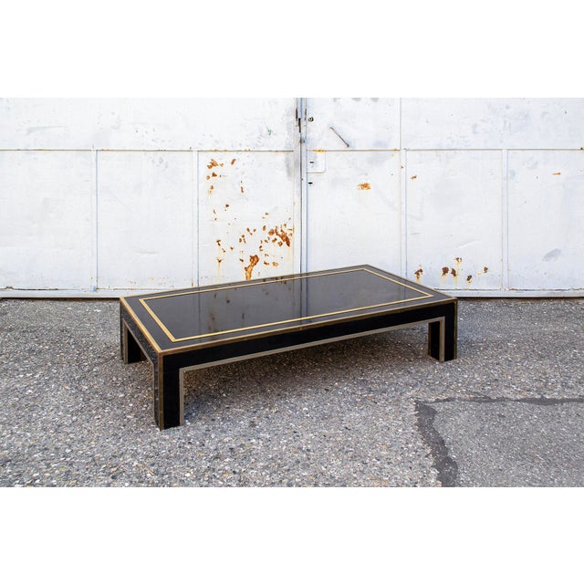 Coffee table with black laminate frame, brass and nickel-plated metal bands. 1970s