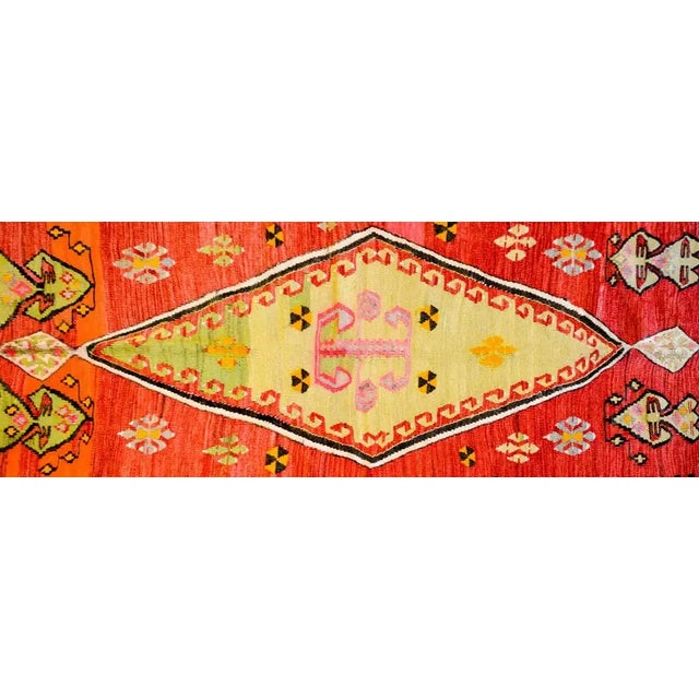 An early 20th century Turkish Kilim rug with a brilliant spring green diamond medallion amidst a field of geometric...
