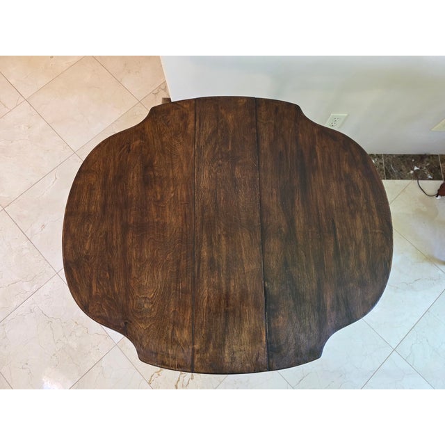 A stunning and highly functional antique Jacobean Revival gateleg table, circa 1900-1920s. This piece captures the essence...