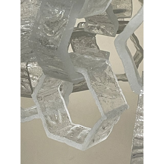 A 1970s chandelier featuring a cascade of Murano glass hexagons. The interior features a nickel-plated metal structure...