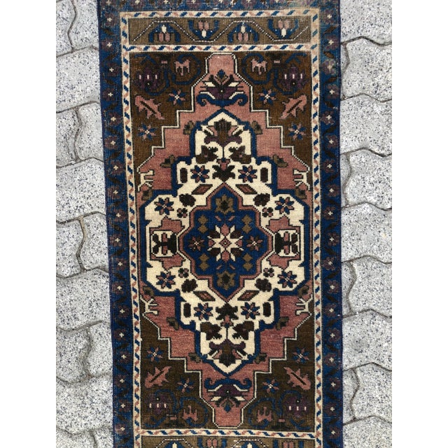 This is a vintage Turkish Oushak rug from the 1960s. The piece was hand-knotted.