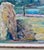 Impressionist oil painting depicting harvest time with hay stacks on a farm with a rushing river with hills in the...