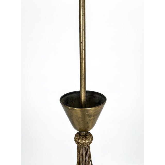 Elegant Swedish Grace / Art Deco chandelier executed in patinated brass with three gracefully curved arms and frosted...