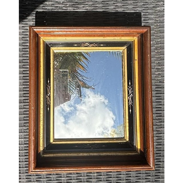 Antique Victorian Ebonized and Gilded Mirror with Reverse-Painted Glass This exquisite late 19th to early 20th-century...