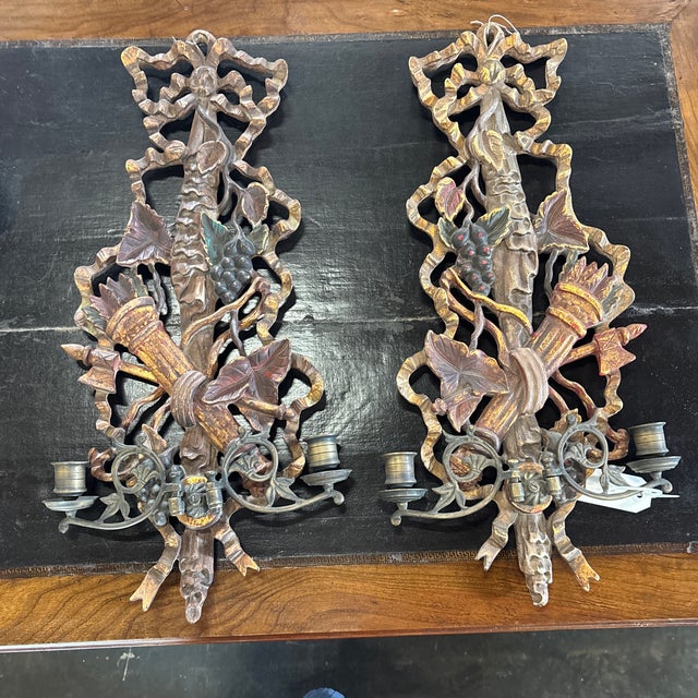 A pair of Mid 20th century hand carved wood sconces with bronze bobeches. These lovely large panel sconces are hand carved...