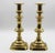 Circa 1860 pair of brass 11" candlesticks, English. Baluster form on chamfered corner square bases. Ring turned, built on...
