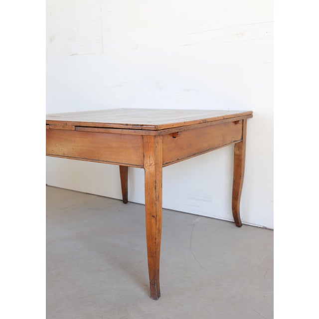 An elegant 18th century Venetian table crafted from warm, honey-toned cherrywood, featuring refined proportions and...