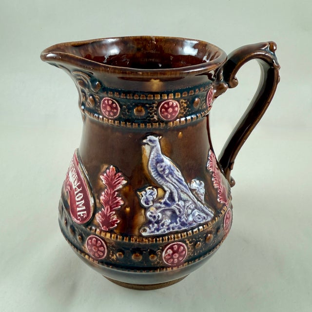 A Measham – Bargeware Milk Jug impressed with the saying, “Home Sweet Home”, England, circa 1880. Finished in a dark brown...