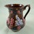 A Measham – Bargeware Milk Jug impressed with the saying, “Home Sweet Home”, England, circa 1880. Finished in a dark brown...