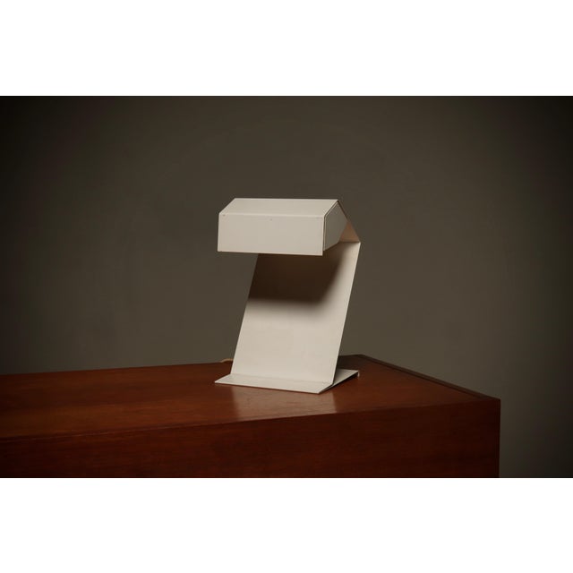 Dutch Modernist table lamp from the 1960s. The lamp is crafted from sheet steel and carefully shaped into beautiful...