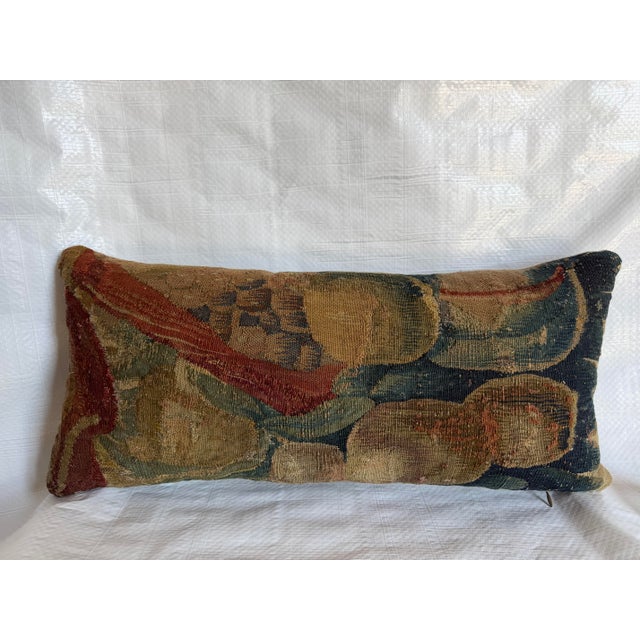 This exceptional antique lumbar pillow is fashioned from a 17th-century Flemish tapestry fragment, preserving a richly...