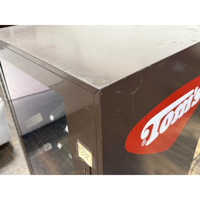 Design Plus Gallery presents a Table Top Vending Machine Dispenser from Tom's. The vintage piece has a nine placements for...