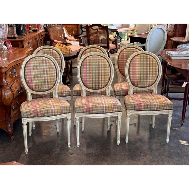 Oval backs and fluted, tapered legs give these 20th century French chairs their Louis XVI style, and the frames are...