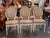 Oval backs and fluted, tapered legs give these 20th century French chairs their Louis XVI style, and the frames are...