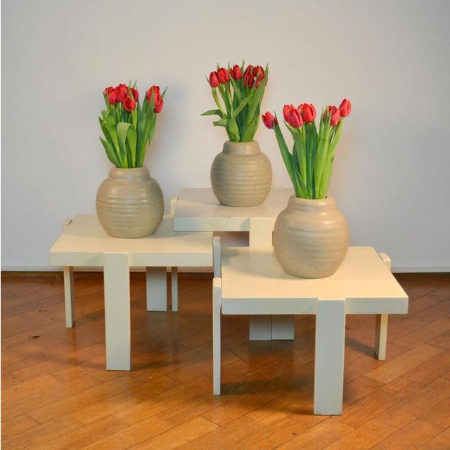 Minimalist set of four nesting tables in descending heights. They are made of beech wood painted cream. Tables can...