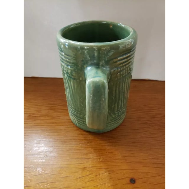 This is a 1920's McCoy Green Stoneware Barrel Mug. It measures 5 1/8" high, 5 1/2" wide to the handle and 3 3/4“ in...