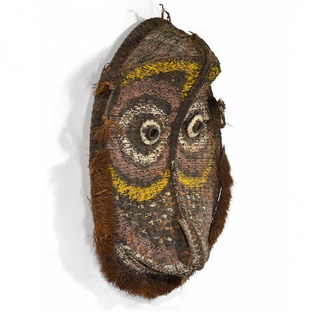 A beautiful and large example of Oceanic art, this delightful woven mask would have been used on the gable of a middle...