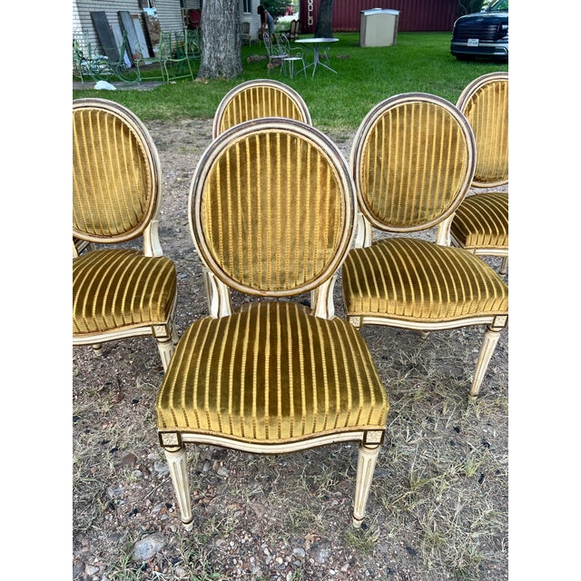 Set of 6 19th Century Louis XVI Dining Chairs featuring hand-carved and painted wood frames with elegant oval backs,...