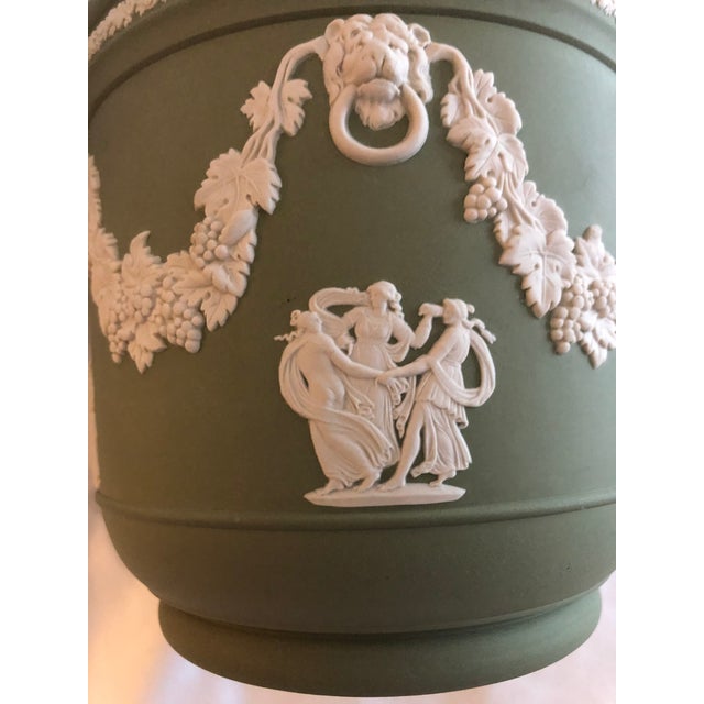 A sage green Wedgwood Jasperware planter featuring white relief Neo classical figures and lion head decoration. The...