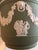 A sage green Wedgwood Jasperware planter featuring white relief Neo classical figures and lion head decoration. The...