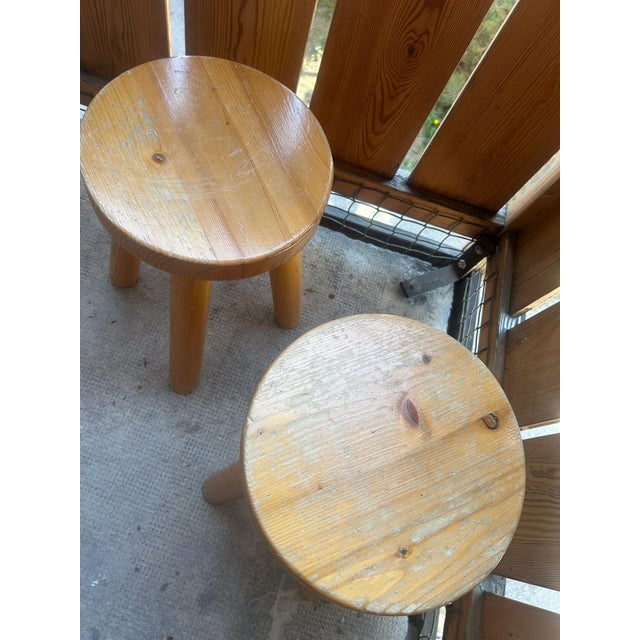 Pair of Charlotte Perriand stools, 1965, for Les Arcs 1600 — an iconic design of Alpine modernism. Characterized by their...