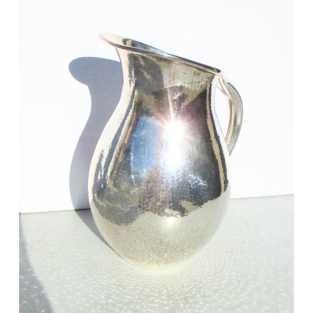 Handmade hammered silver pitcher from Industria Argentina, Italy. Hammer in a very tiny pattern of overlapping marks to...