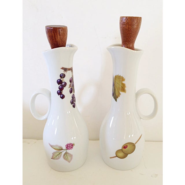 An English oil and vinegar set by the Royal Worcester factory in the Evesham pattern. There is a chip off one of the corks...