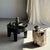 Side table in petrified wood, predominantly white and beige with black speckles. Petrified wood is a fossilized wood (same...