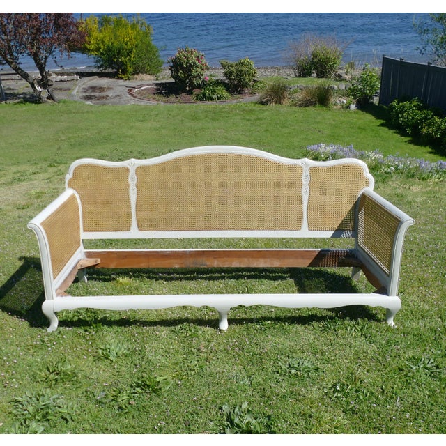Likely Italian, in the French Provincial style settee featuring an elegantly carved wood frame with a graceful silhouette....